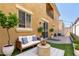 A cozy patio area features stylish seating, a small tree, and string lights above at 1367 S Country Club Dr # 1320, Mesa, AZ 85210