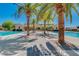 Beautiful community pool area lined with palm trees and lounge chairs for relaxation and enjoyment at 1367 S Country Club Dr # 1320, Mesa, AZ 85210