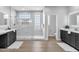 Stylish bathroom featuring dual vanities, a frameless glass shower, and modern tile at 1526 E Glacier Pl, Chandler, AZ 85249