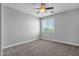 Bright bedroom features soft carpet, a ceiling fan, and a window for natural light at 1526 E Glacier Pl, Chandler, AZ 85249
