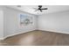 Bright bedroom featuring sleek hardwood floors, a modern ceiling fan, and a window at 1526 E Glacier Pl, Chandler, AZ 85249