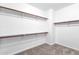 Spacious walk-in closet featuring carpet floors, and ample shelves and storage at 1526 E Glacier Pl, Chandler, AZ 85249