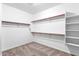 Walk-in closet featuring carpet floors and ample shelving and storage space at 1526 E Glacier Pl, Chandler, AZ 85249