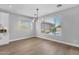 Bright dining area with backyard views, stylish light fixture and wood floors at 1526 E Glacier Pl, Chandler, AZ 85249