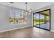 Modern dining area with large backyard view windows and a sliding glass door at 1526 E Glacier Pl, Chandler, AZ 85249