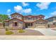 Two-story home featuring a three car garage, neutral stucco and stone accents with professionally landscaped front yard at 1526 E Glacier Pl, Chandler, AZ 85249