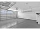 Garage with epoxy flooring, overhead storage racks, and ample space for storage or parking at 1526 E Glacier Pl, Chandler, AZ 85249
