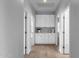 Hallway featuring built in cabinetry, hardwood floors, and three separate doorways at 1526 E Glacier Pl, Chandler, AZ 85249
