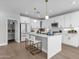Bright kitchen features white cabinets, stainless steel appliances, a central island with seating, and plenty of natural light at 1526 E Glacier Pl, Chandler, AZ 85249