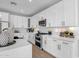 Bright kitchen with white cabinets, stainless steel appliances, and quartz countertops offers a stylish and functional design at 1526 E Glacier Pl, Chandler, AZ 85249
