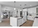 Bright and spacious kitchen featuring white cabinets, quartz countertops and a large center island at 1526 E Glacier Pl, Chandler, AZ 85249