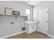 Bright laundry room with white cabinetry, floating shelf, and decorative wall art at 1526 E Glacier Pl, Chandler, AZ 85249
