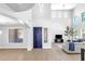 Bright living room features a high ceiling, light wood floors, and a comfortable seating area with a striking blue front door at 1526 E Glacier Pl, Chandler, AZ 85249