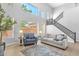 Bright living room features a high ceiling, light wood floors, comfortable seating area, and a staircase at 1526 E Glacier Pl, Chandler, AZ 85249