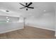 Open area with hardwood floors, recessed lighting, fan, and hallway access at 1526 E Glacier Pl, Chandler, AZ 85249