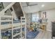 Fun bedroom with triple bunk bed, ceiling fan, and natural light at 156 N Hawes Rd # 68, Mesa, AZ 85207