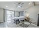 Bright bedroom featuring a ceiling fan, large windows, and light gray floors at 156 N Hawes Rd # 68, Mesa, AZ 85207