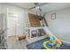 Bedroom with bunk bed, play area, ceiling fan and gray wood laminate flooring at 156 N Hawes Rd # 68, Mesa, AZ 85207