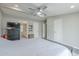 Large primary bedroom featuring a ceiling fan, and a door to the bathroom at 156 N Hawes Rd # 68, Mesa, AZ 85207