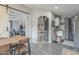 Open floor plan with a view into the dining room, featuring a sliding barn door and access to the kitchen at 156 N Hawes Rd # 68, Mesa, AZ 85207