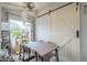 Inviting dining room with barn door accent, a natural wood table, and ample light, perfect for Gathering meals at 156 N Hawes Rd # 68, Mesa, AZ 85207