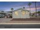 Charming manufactured home with desert landscaping and carport in a mobile home community at 156 N Hawes Rd # 68, Mesa, AZ 85207