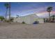 Manufactured home with desert landscaping and palm trees at dusk at 156 N Hawes Rd # 68, Mesa, AZ 85207