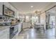 Bright kitchen with white cabinetry, stainless appliances, and breakfast table at 156 N Hawes Rd # 68, Mesa, AZ 85207