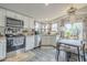 Modern kitchen featuring white cabinets, stainless steel appliances, and adjacent dining area at 156 N Hawes Rd # 68, Mesa, AZ 85207