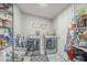 Convenient laundry room with modern washer and dryer, storage shelves, and ample space for laundry tasks at 156 N Hawes Rd # 68, Mesa, AZ 85207