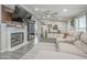 Open living room showcasing a fireplace, modern décor, and plush gray sofa at 156 N Hawes Rd # 68, Mesa, AZ 85207