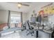 Functional home office space with dual monitors, desk setup, and relaxing lounge area, perfect for work or play at 156 N Hawes Rd # 68, Mesa, AZ 85207