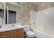 Bathroom features a bath tub with shower, toilet, sink, vanity, mirror and wallpaper at 15835 W Woodlands Ave, Goodyear, AZ 85338