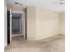 A well-lit bedroom with neutral walls, carpet, ceiling fan, and connecting hallway and rooms at 15835 W Woodlands Ave, Goodyear, AZ 85338