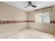 Bedroom with neutral carpet, walls, decorative border, and window with curtains at 15835 W Woodlands Ave, Goodyear, AZ 85338