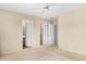 Bright bedroom features neutral walls, carpet, ceiling fan, and doors to adjacent rooms at 15835 W Woodlands Ave, Goodyear, AZ 85338