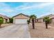 Charming single-story home featuring a two-car garage and desert landscaping at 15835 W Woodlands Ave, Goodyear, AZ 85338