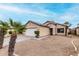 Single-story home with desert landscaping, two-car garage and tile roof at 15835 W Woodlands Ave, Goodyear, AZ 85338