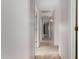 Hallway with neutral walls, carpet, ceiling light, and doors to other rooms at 15835 W Woodlands Ave, Goodyear, AZ 85338