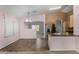 Bright kitchen featuring stainless steel refrigerator, a breakfast bar, and natural light at 15835 W Woodlands Ave, Goodyear, AZ 85338