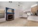 Inviting living space featuring a fireplace and open access to the kitchen at 15835 W Woodlands Ave, Goodyear, AZ 85338