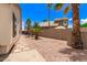 This backyard features a desert landscape, block wall, and walking stones to the side of the home at 16023 S 30Th Pl, Phoenix, AZ 85048