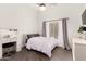 Clean bedroom with white walls, fan, desk and natural light from a large window at 16023 S 30Th Pl, Phoenix, AZ 85048