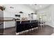 Bright kitchen with granite countertops, dark wood flooring, a breakfast bar, and white cabinetry at 16023 S 30Th Pl, Phoenix, AZ 85048