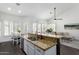 An open-concept kitchen with a granite countertop, stainless steel appliances, and views into the living area at 16023 S 30Th Pl, Phoenix, AZ 85048