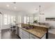 Stylish kitchen showcasing granite countertops, stainless steel appliances, and an island with seating at 16023 S 30Th Pl, Phoenix, AZ 85048