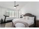 A bright main bedroom with plantation shutters, a ceiling fan, and neutral decor at 16023 S 30Th Pl, Phoenix, AZ 85048