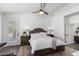 Main bedroom featuring plantation shutters, ceiling fan, and stylish neutral decor at 16023 S 30Th Pl, Phoenix, AZ 85048