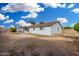 This backyard features a white house, block fence, grass, and trees at 17616 N 20Th Dr, Phoenix, AZ 85023