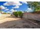 Expansive backyard featuring a concrete block fence, green bushes and low maintenance landscaping at 17616 N 20Th Dr, Phoenix, AZ 85023